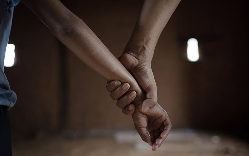 Protective handshake symbolizing trust and cybersecurity.