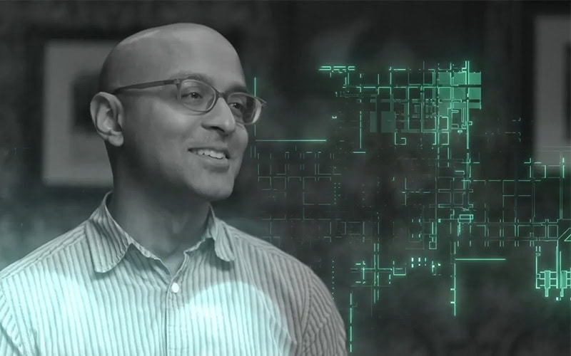 Cybersecurity professional reviewing digital threat data with futuristic interface.