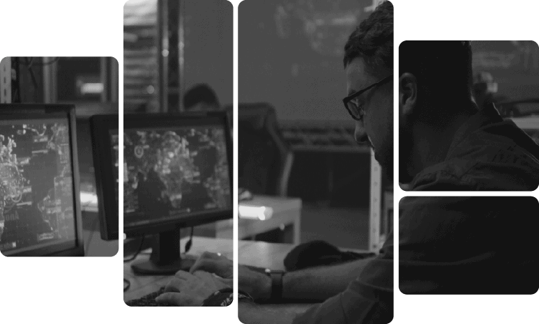 Cybersecurity analyst analyzing threat data on multiple monitors.