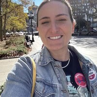 Cybersecurity professionals analyzing data on a laptop outdoors.
